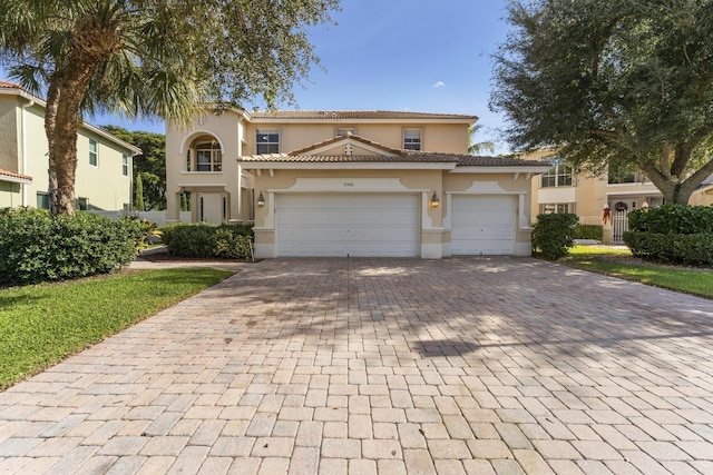 mediterranean / spanish-style house with a garage