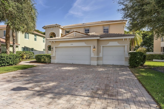 mediterranean / spanish house with a garage