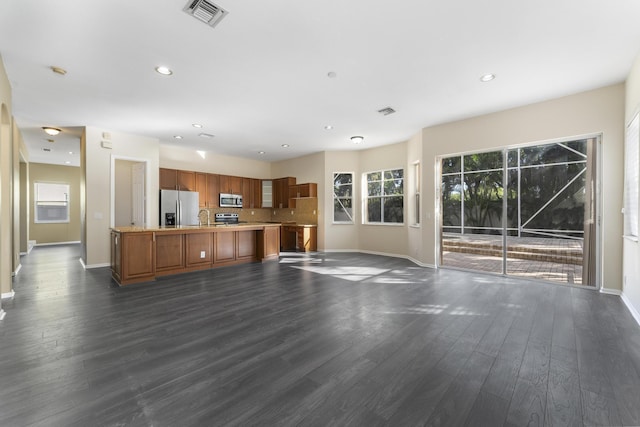 unfurnished living room with sink and dark hardwood / wood-style floors