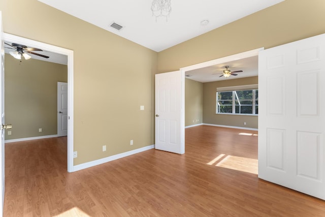 empty room with ceiling fan and hardwood / wood-style floors