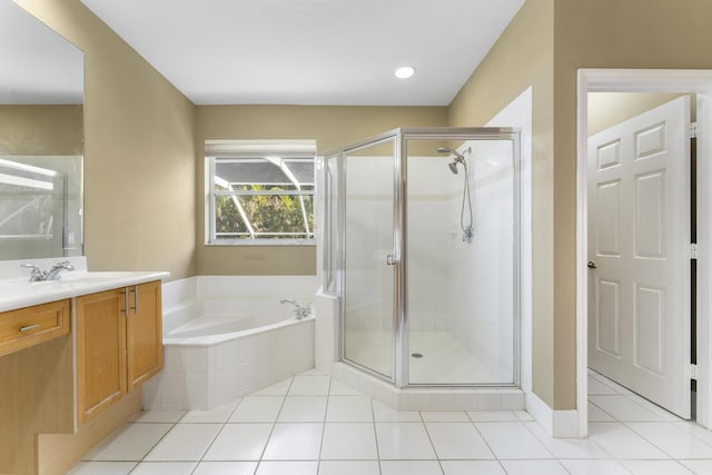 bathroom with tile patterned flooring, vanity, and shower with separate bathtub