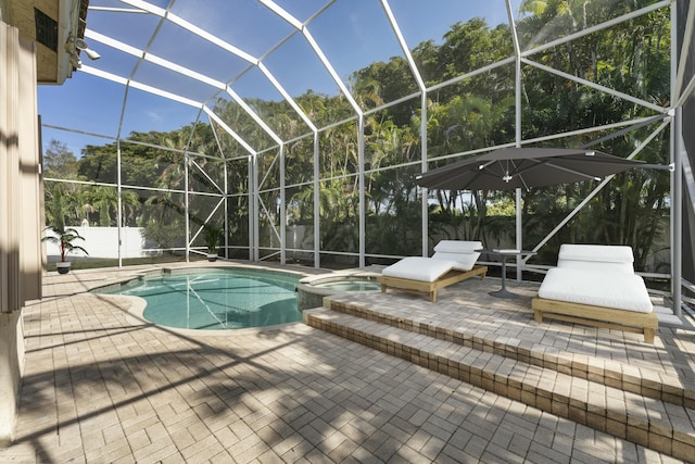 view of swimming pool with a lanai, a patio area, and an in ground hot tub