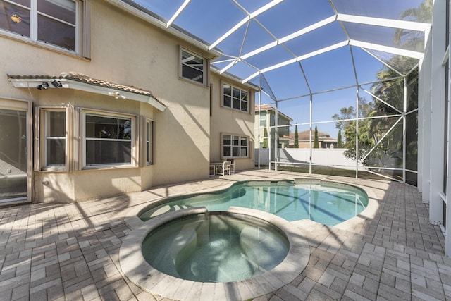 view of pool featuring an in ground hot tub, a lanai, and a patio area