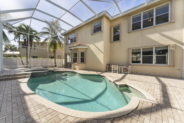 view of pool featuring a lanai, an in ground hot tub, and a patio