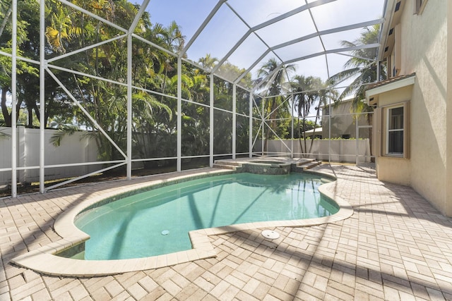 view of swimming pool with an in ground hot tub, a patio, and glass enclosure