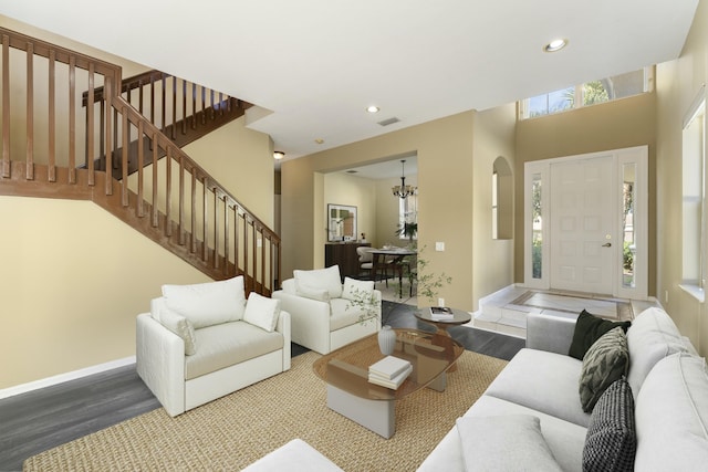 living room with hardwood / wood-style floors, plenty of natural light, and a notable chandelier