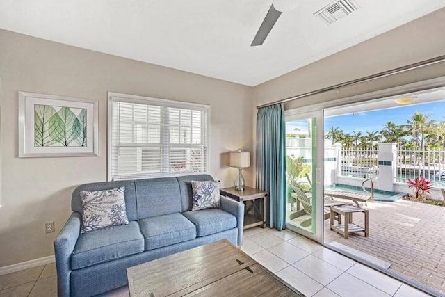 living room with ceiling fan and light tile patterned flooring