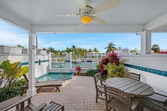 view of patio / terrace with ceiling fan and an in ground hot tub