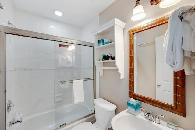 full bathroom with toilet, enclosed tub / shower combo, and sink