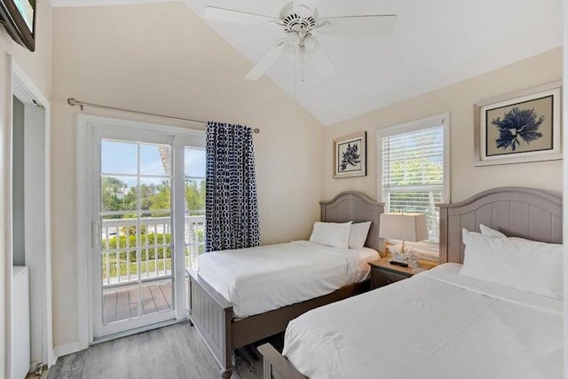 bedroom with ceiling fan, access to exterior, light hardwood / wood-style flooring, and lofted ceiling