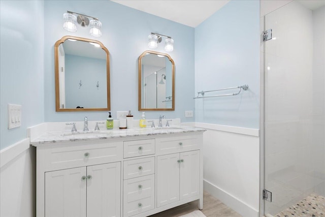 bathroom featuring hardwood / wood-style flooring, vanity, and a shower with door