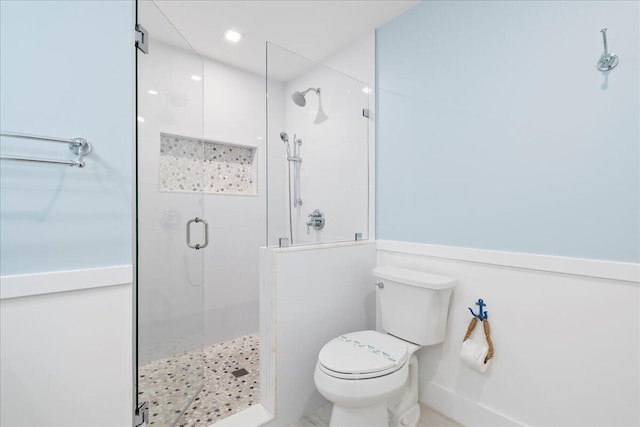 bathroom with an enclosed shower and toilet