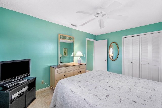 bedroom with ceiling fan, a closet, and light tile patterned flooring