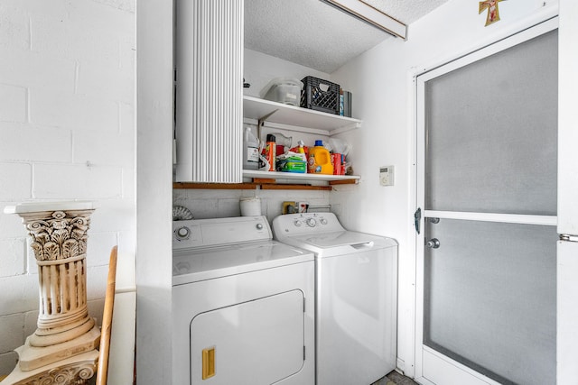 10070 Eaglewood Rd Unit B, Boynton Beach, FL 33436 - washroom with washer and dryer, a textured ceiling, and concrete block wall