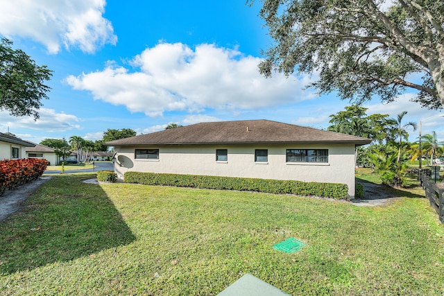 view of side of property with a lawn