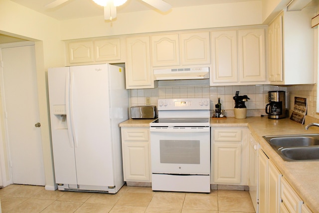 10070 Eaglewood Rd Unit B, Boynton Beach, FL 33436 - kitchen featuring white appliances, under cabinet range hood, tasteful backsplash, and light tile patterned floors