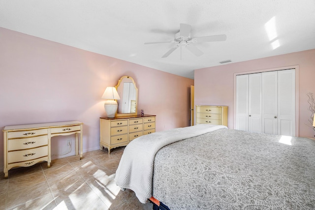 bedroom with ceiling fan, a closet, and light tile patterned flooring