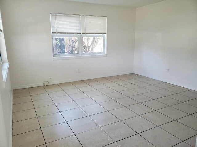 empty room with light tile patterned flooring