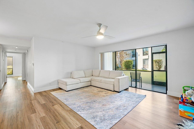 living room with ceiling fan and light hardwood / wood-style floors