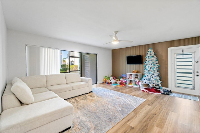 living room with hardwood / wood-style flooring and ceiling fan