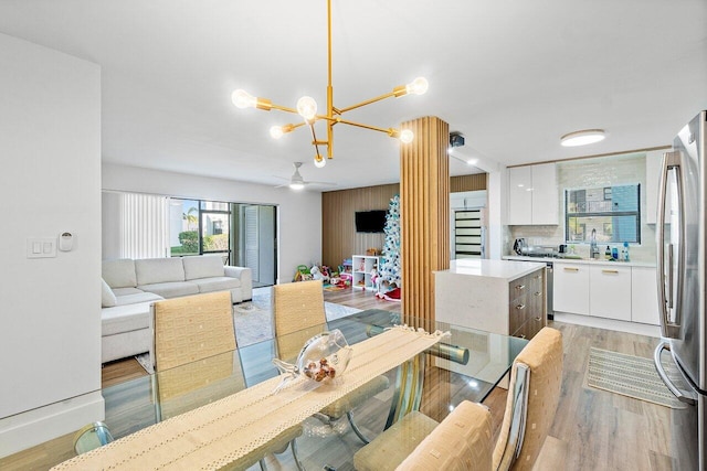 dining area featuring a notable chandelier and light wood-type flooring