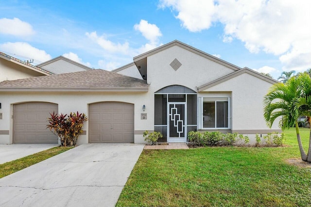 view of front of house with a front yard and a garage