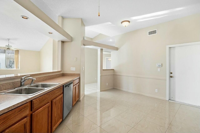 kitchen with sink, stainless steel dishwasher, ceiling fan, light tile patterned floors, and a textured ceiling