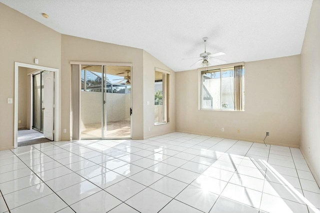 unfurnished room with light tile patterned floors, a textured ceiling, vaulted ceiling, and ceiling fan