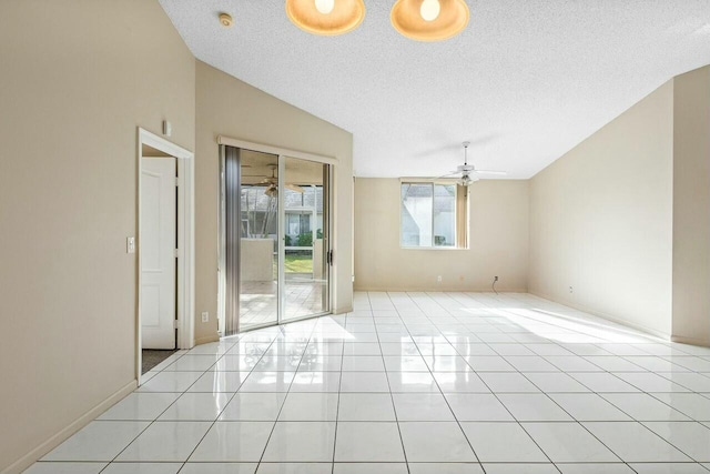 tiled spare room with ceiling fan, lofted ceiling, and a textured ceiling