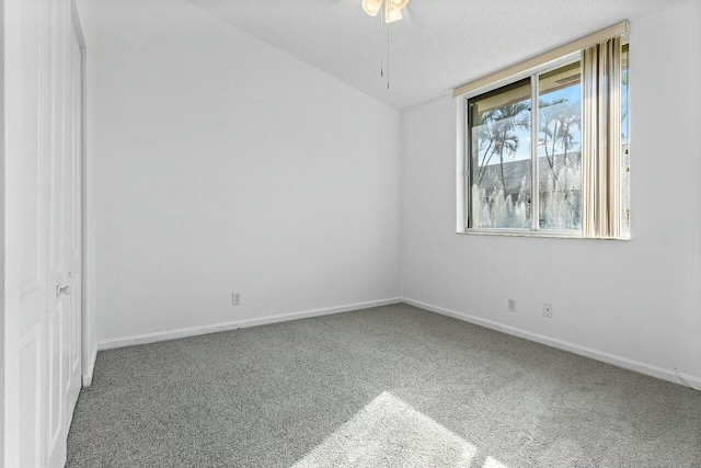 carpeted empty room featuring a textured ceiling and ceiling fan