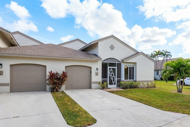 view of front of house featuring a garage and a front lawn