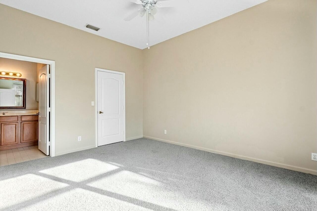 unfurnished bedroom featuring connected bathroom, ceiling fan, and carpet floors