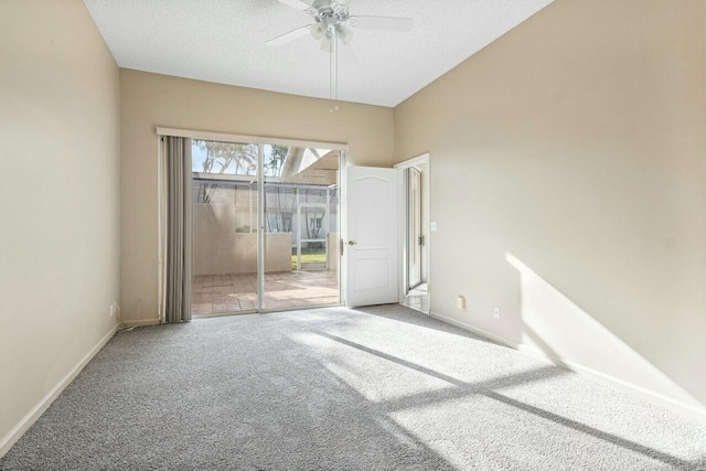 carpeted empty room featuring ceiling fan and a textured ceiling