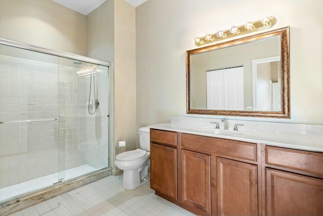 bathroom featuring toilet, vanity, tile patterned floors, and walk in shower