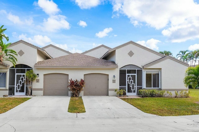 view of front of property featuring a garage and a front lawn