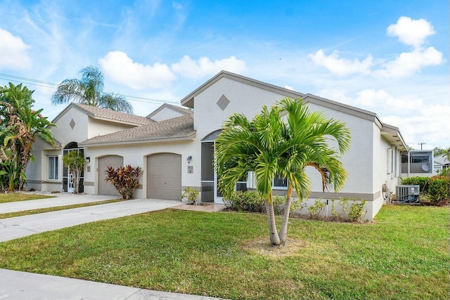 view of front of property featuring a front yard, a garage, and central AC unit