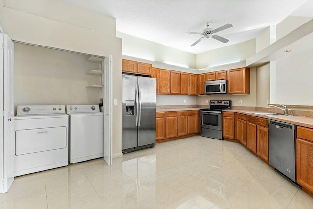 kitchen with ceiling fan, sink, stainless steel appliances, and a textured ceiling