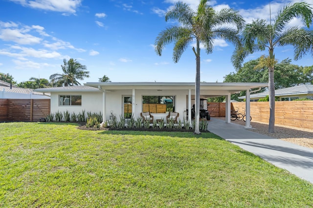 view of front facade featuring a front lawn and a carport