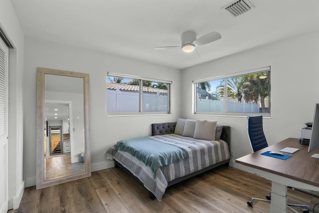 bedroom with hardwood / wood-style flooring, ceiling fan, and a closet