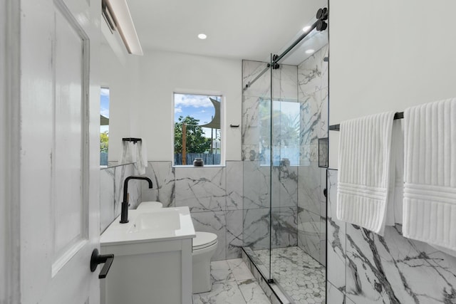 bathroom with vanity, a shower with door, toilet, and tile walls