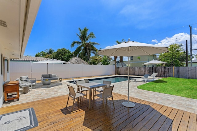 deck featuring a lawn, an outdoor living space, a fenced in pool, and a patio