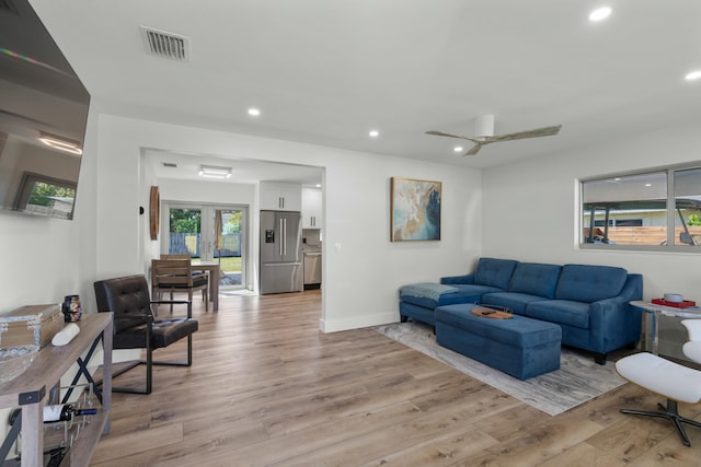 living room with french doors, light hardwood / wood-style flooring, and ceiling fan