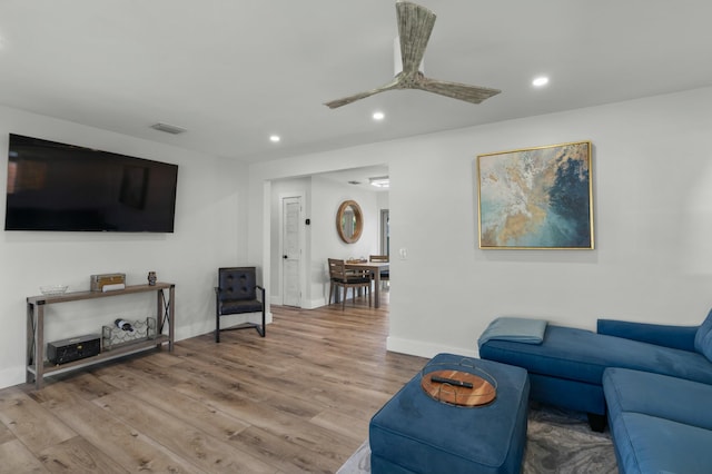 living room with ceiling fan and light hardwood / wood-style floors