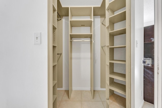 spacious closet featuring light tile patterned floors