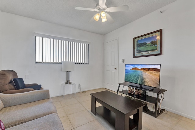 tiled living room featuring ceiling fan and a textured ceiling