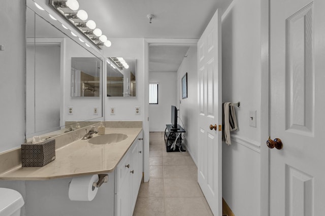 bathroom featuring tile patterned flooring, vanity, and toilet