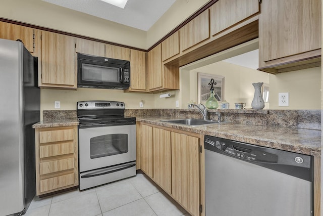 kitchen featuring light brown cabinets, sink, light tile patterned floors, a textured ceiling, and stainless steel appliances