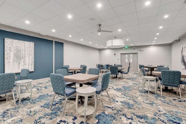 dining space featuring ceiling fan and carpet