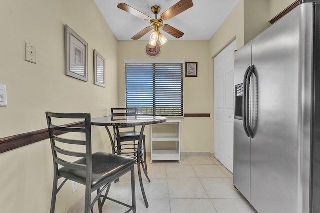 tiled dining area with ceiling fan