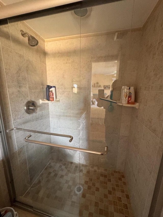 bathroom with a shower with door